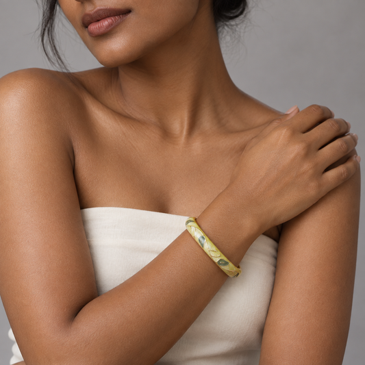 Model wearing Harit Bela enamel bangle against neutral studio background