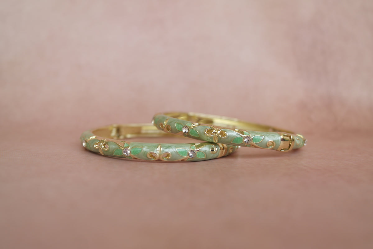 Anarkali enamel bangle by Rangat — coral flowers bloom across a rich green canvas